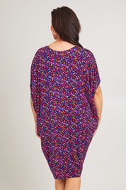 Model Poppy wearing size 16 of the Maui Dress in colour Confetti (Blue), from the back