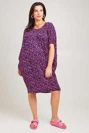 Model Poppy wearing size 16 of the Maui Dress in colour Confetti (Blue), from the front, showing the whole outfit