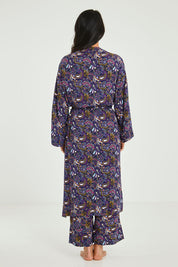 Model Katie wearing size S of the Roya Robe in colour Paisley (Blue), from the back