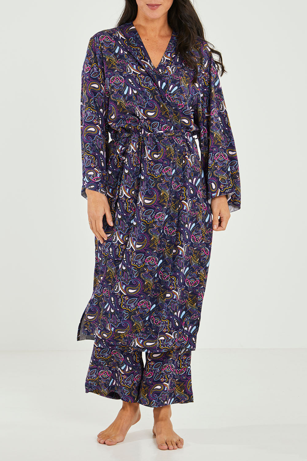 Model Katie wearing size S of the Roya Robe in colour Paisley (Blue), from the front, cropped image