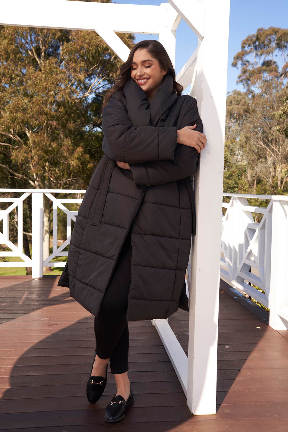 A model wearing the Shawl Puffer Jacket in colour Black (Black), from the front, showing the whole outfit