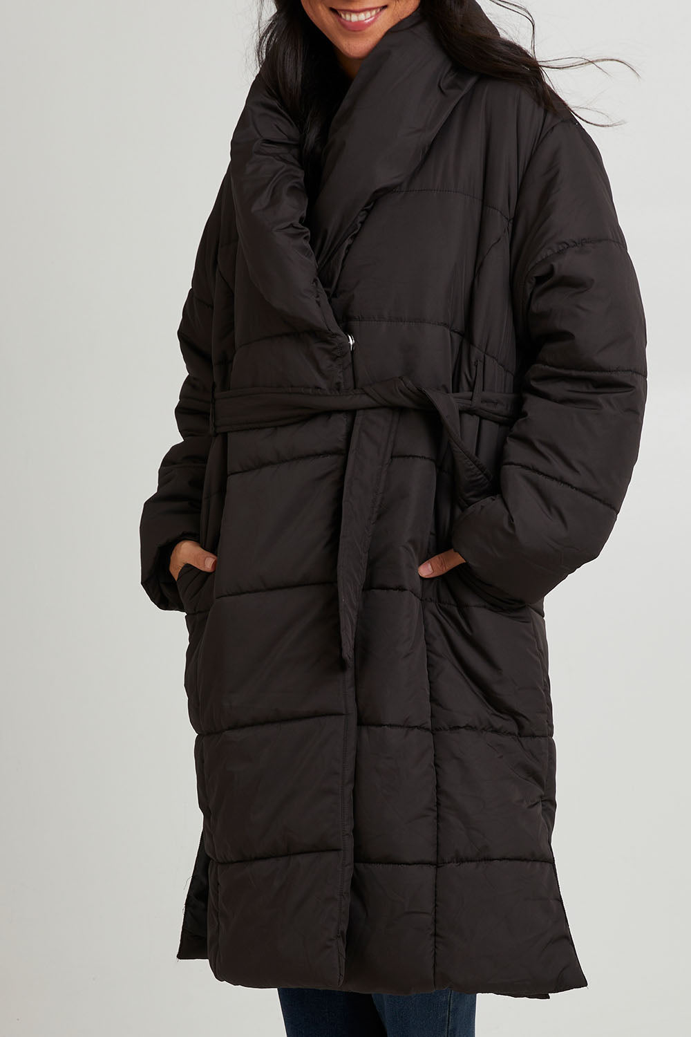 Model Katie wearing size 10 of the Shawl Puffer Jacket in colour Black (Black), from the front, cropped image