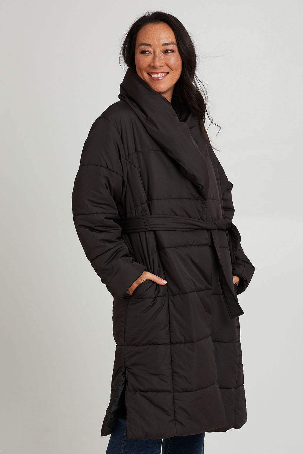 Model Katie wearing size 10 of the Shawl Puffer Jacket in colour Black (Black), from the front, cropped image