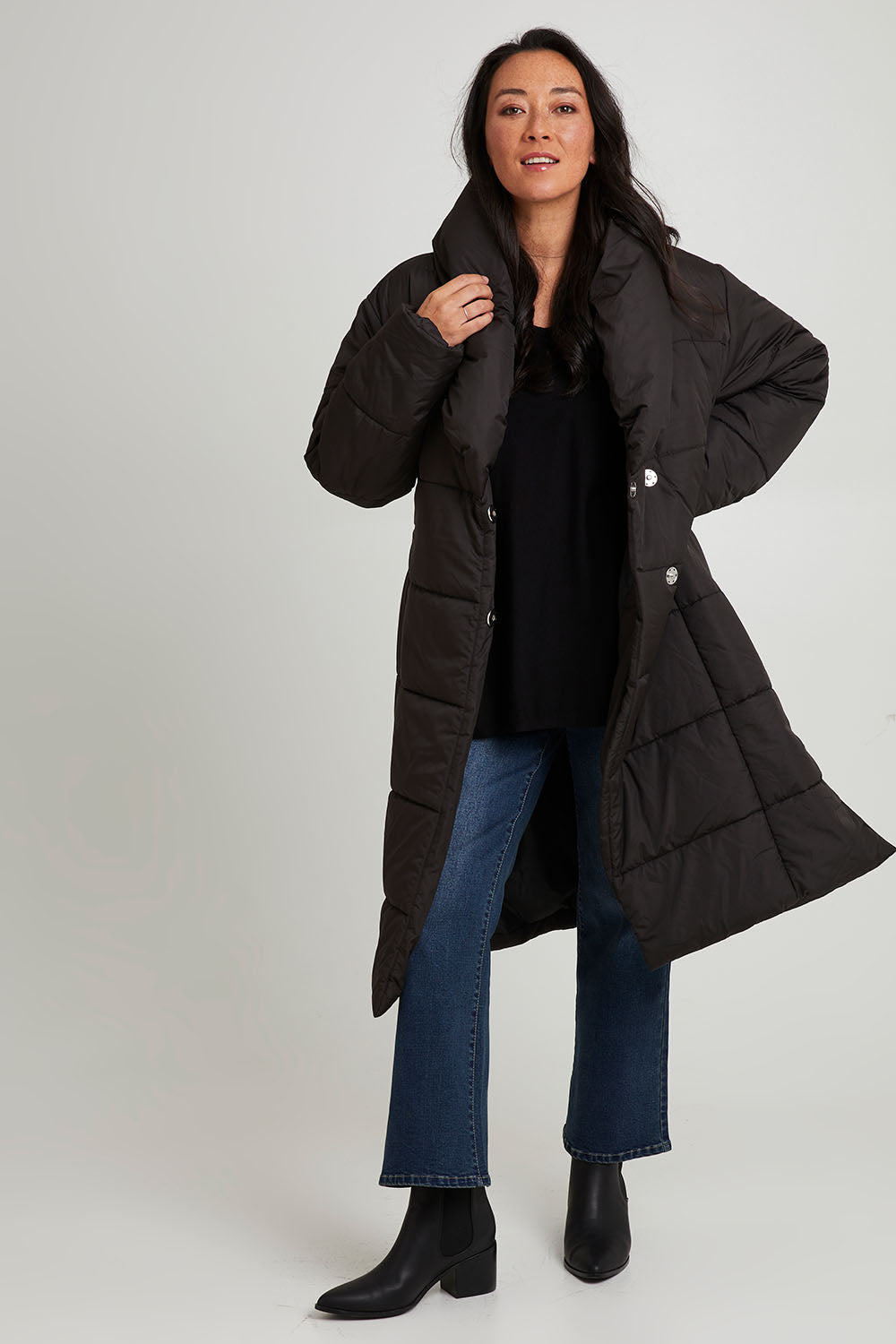 Model Katie wearing size 10 of the Shawl Puffer Jacket in colour Black (Black), from the front, showing the whole outfit