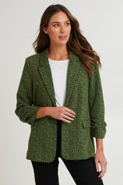 Model Madeline wearing size 10 of the Leopard Jacquard Blazer in colour Leopard (Green), from the front, cropped image