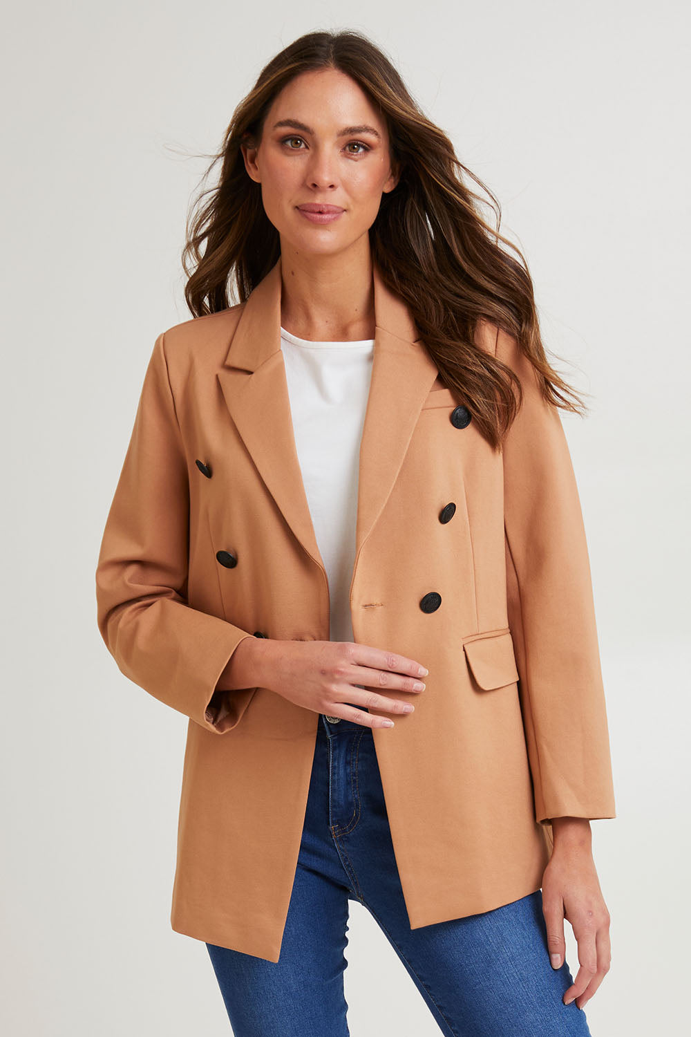 Model Madeline wearing size 10 of the Kaisley Blazer in colour Tan, from the front, cropped image