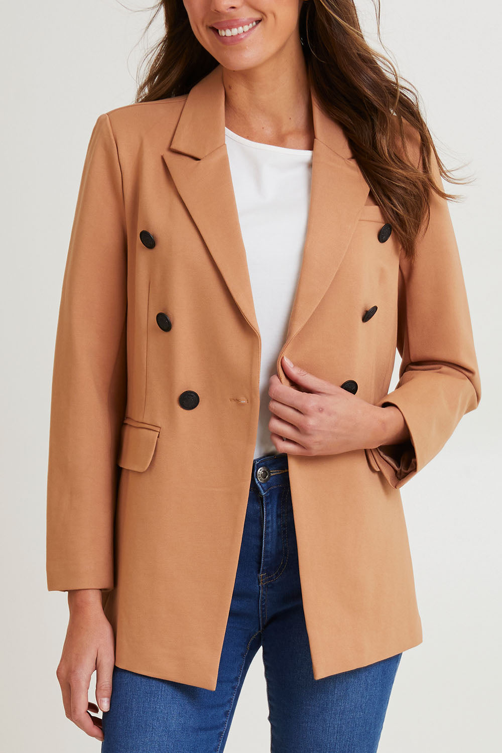 Model Madeline wearing size 10 of the Kaisley Blazer in colour Tan, from the front, cropped image