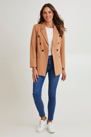 Model Madeline wearing size 10 of the Kaisley Blazer in colour Tan, from the front, showing the whole outfit
