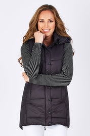 Model Emma wearing size 10 of the Jayce Long Puffer Vest in colour Black (Black), from the front, cropped image