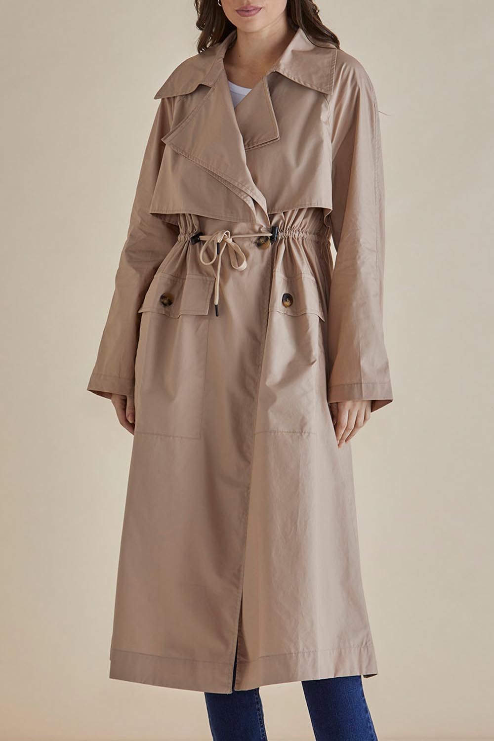 A model wearing the Parker Coat in colour Pebble, from the front, cropped image