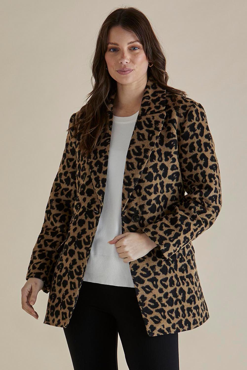 A model wearing the Prague Coat in colour Animal, from the front, cropped image
