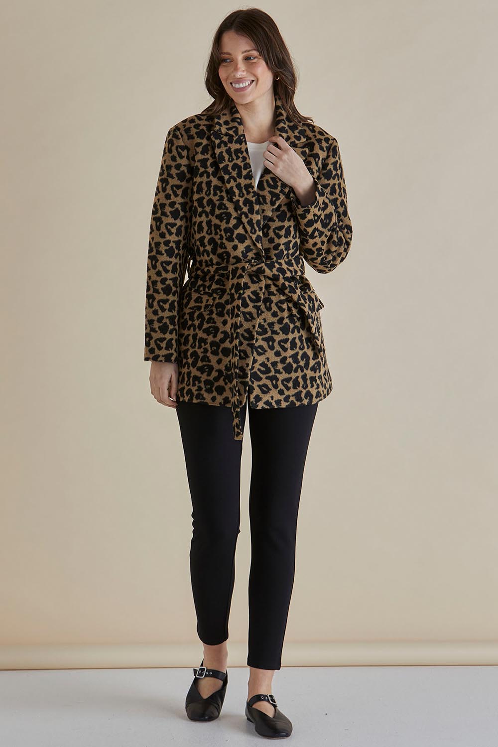 A model wearing the Prague Coat in colour Animal, from the front, showing the whole outfit
