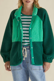 A model wearing the Franklin Fleecy Jacket in colour Green (Green), from the front, cropped image
