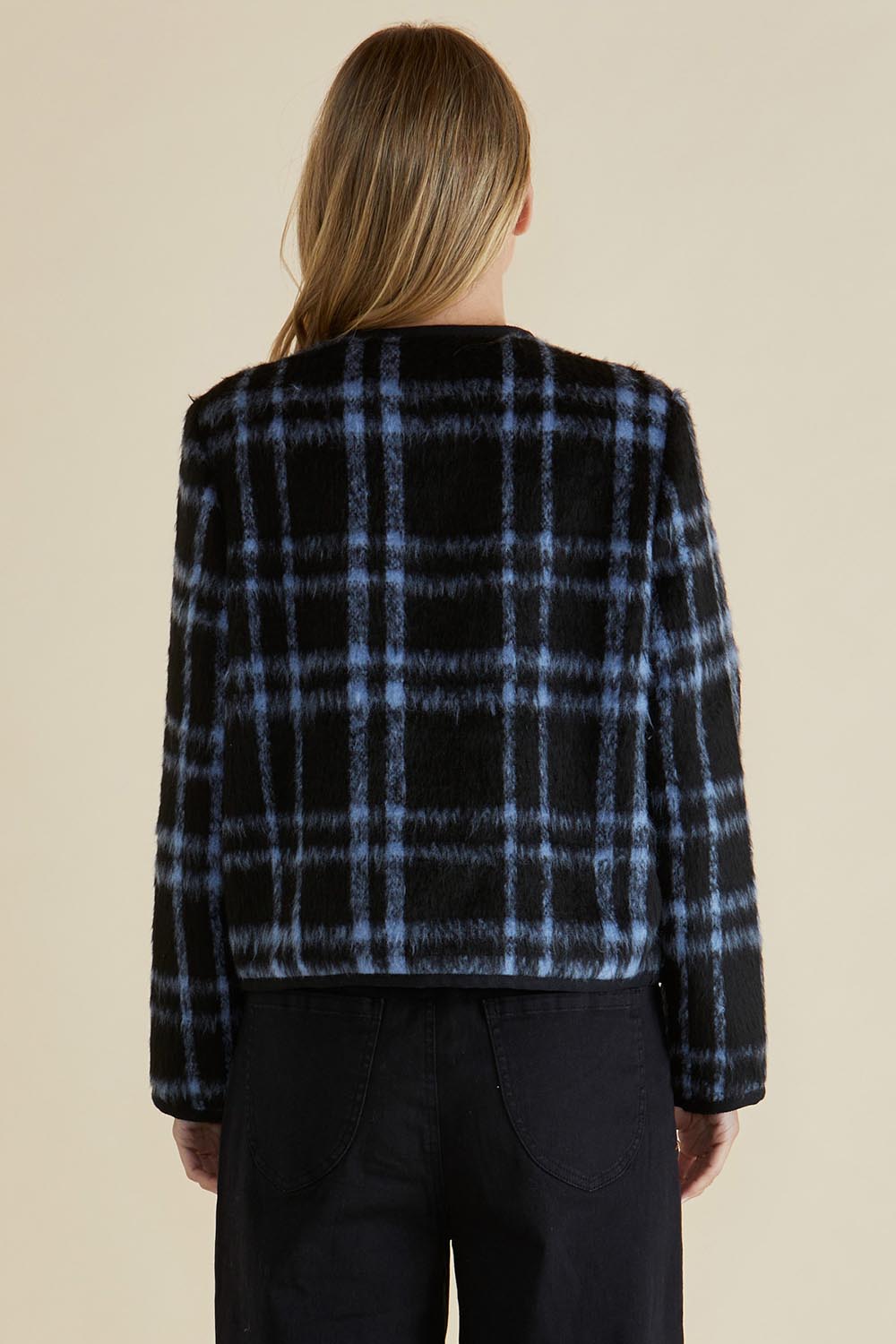 A model wearing the Charlie Check Coat in colour Bluecheck (Blue), from the back