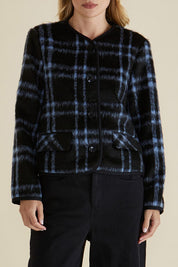 A model wearing the Charlie Check Coat in colour Bluecheck (Blue), from the front, cropped image