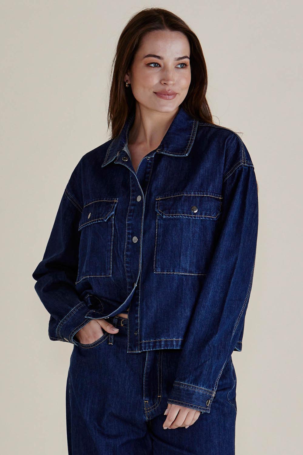 A model wearing the Selby Denim Jacket in colour Darkblue (Blue), from the front, cropped image