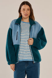 A model wearing the Jayne Fleece Jacket in colour Tealblue (Blue), from the front, cropped image