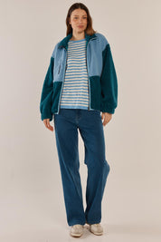 A model wearing the Jayne Fleece Jacket in colour Tealblue (Blue), from the front, showing the whole outfit