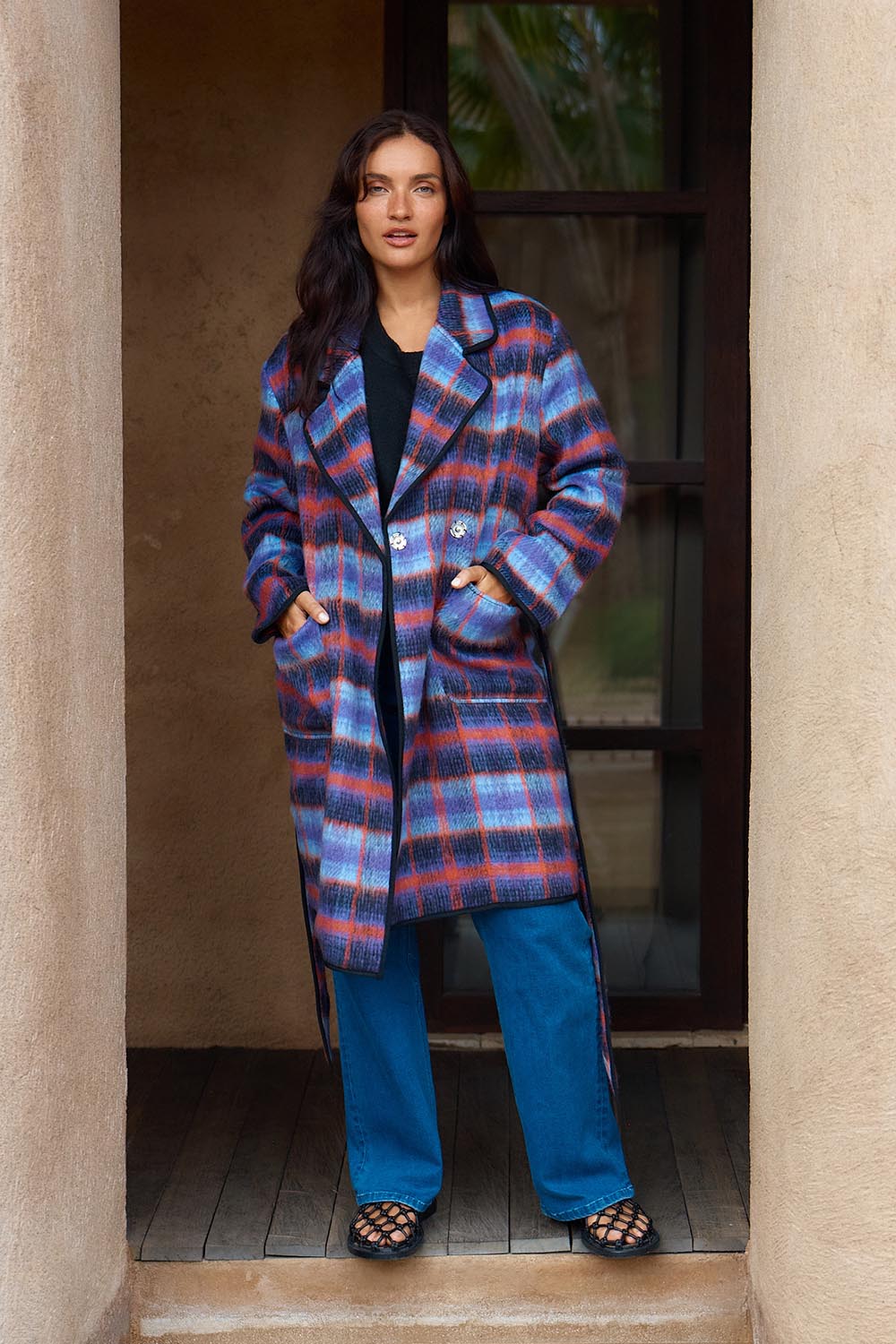 A model wearing the Oslo Coat in colour Purple (Purple), from the front, showing the whole outfit
