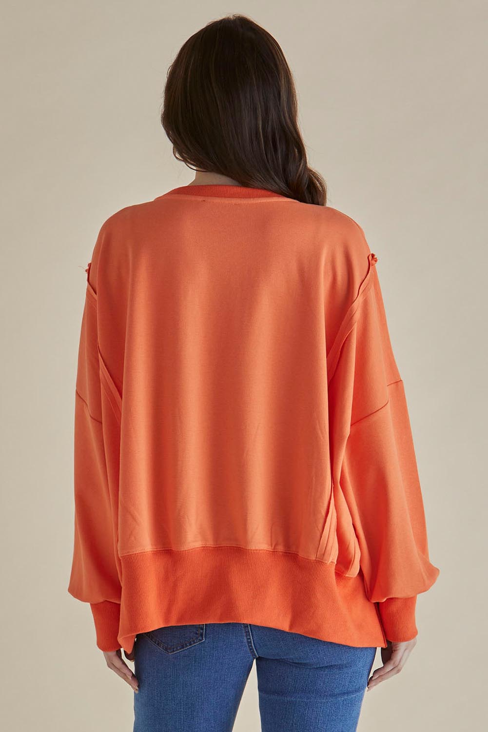 A model wearing the Mykie Cotton Blend Jumper in colour Orange, from the back