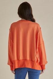 A model wearing the Mykie Cotton Blend Jumper in colour Orange, from the back