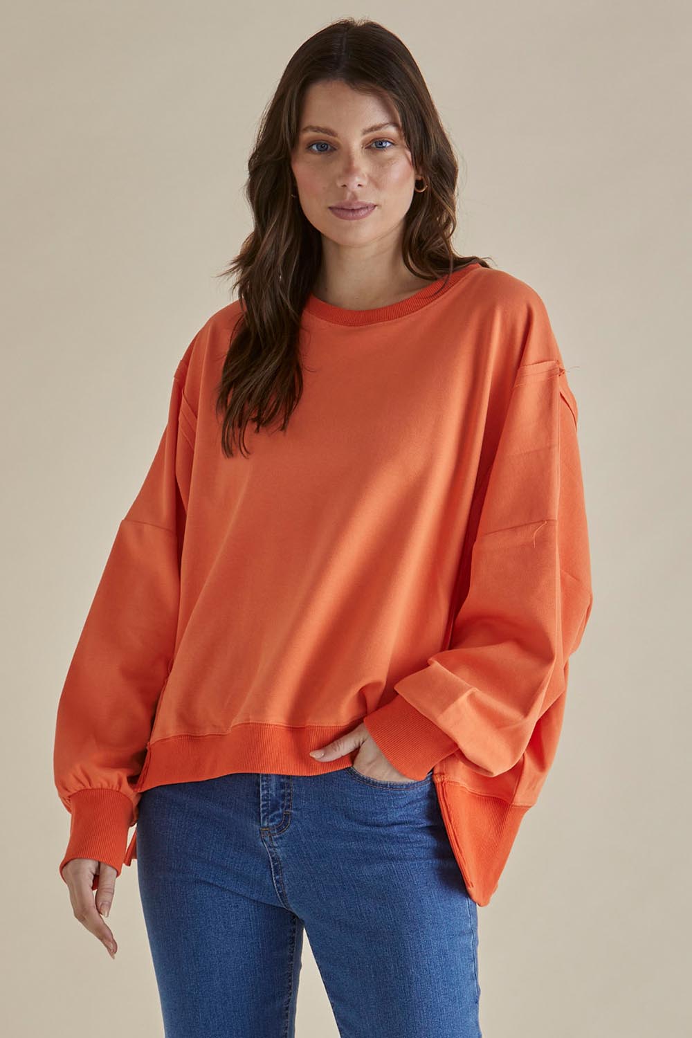 A model wearing the Mykie Cotton Blend Jumper in colour Orange, from the front, cropped image