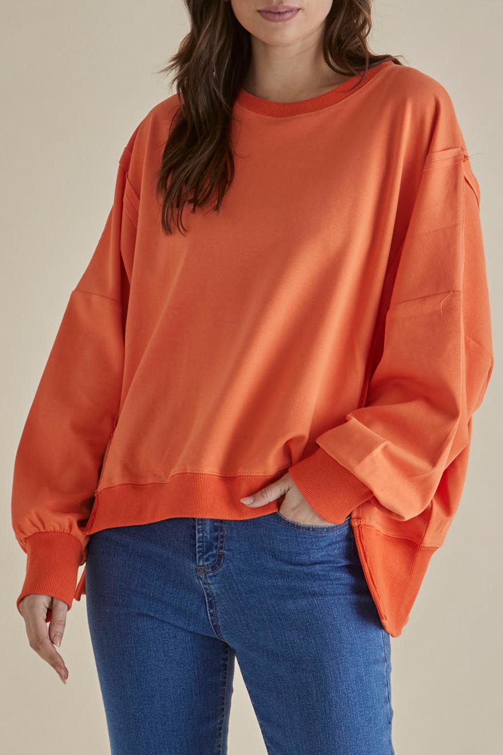 A model wearing the Mykie Cotton Blend Jumper in colour Orange, from the front, cropped image