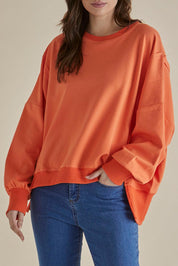 A model wearing the Mykie Cotton Blend Jumper in colour Orange, from the front, cropped image