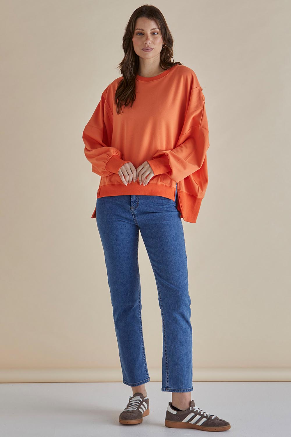 A model wearing the Mykie Cotton Blend Jumper in colour Orange, from the front, showing the whole outfit