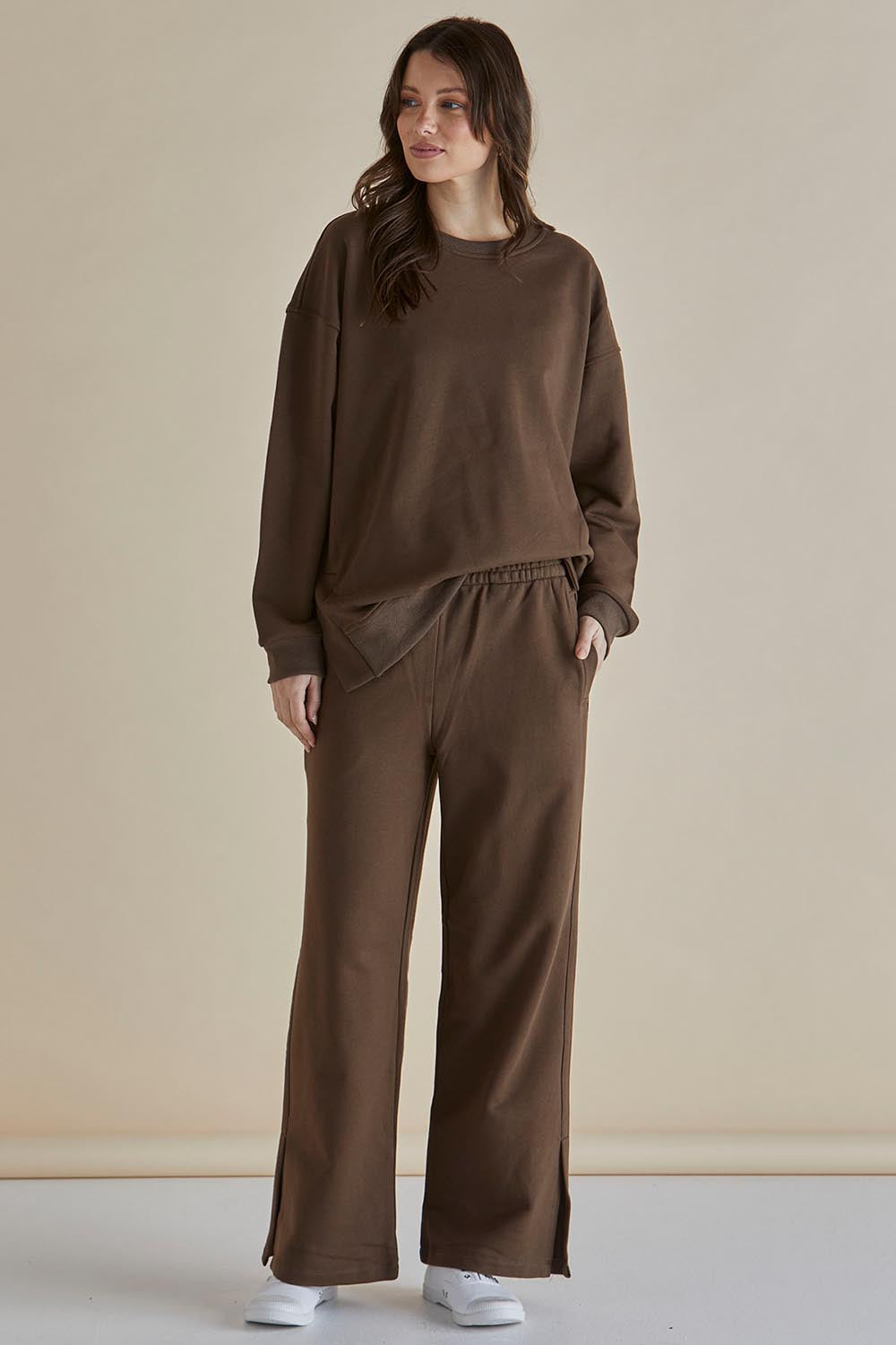 A model wearing the Pace Cotton Jogger in colour Chocolate, from the front, showing the whole outfit