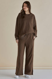 A model wearing the Pace Cotton Jogger in colour Chocolate, from the front, showing the whole outfit