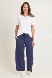 Model Madeline wearing size 10 of the Barrel Leg Cotton Sweatpant in colour Navy (Blue), from the front, showing the whole outfit