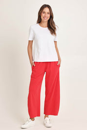 Model Madeline wearing size 10 of the Barrel Leg Cotton Sweatpant in colour Red (Red), from the front, showing the whole outfit
