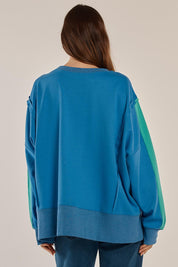 A model wearing the Tania Sweatshirt in colour Bluegreen (Blue), from the back