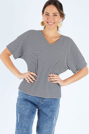 Model Madeline wearing size 10 of the Malta Tee in colour Blkwhite (Black), from the front, cropped image
