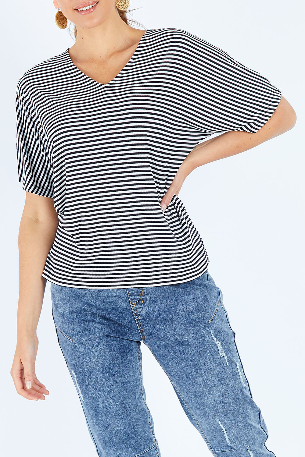 Model Madeline wearing size 10 of the Malta Tee in colour Blkwhite (Black), from the front, cropped image
