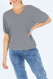 Model Madeline wearing size 10 of the Malta Tee in colour Blkwhite (Black), from the front, cropped image