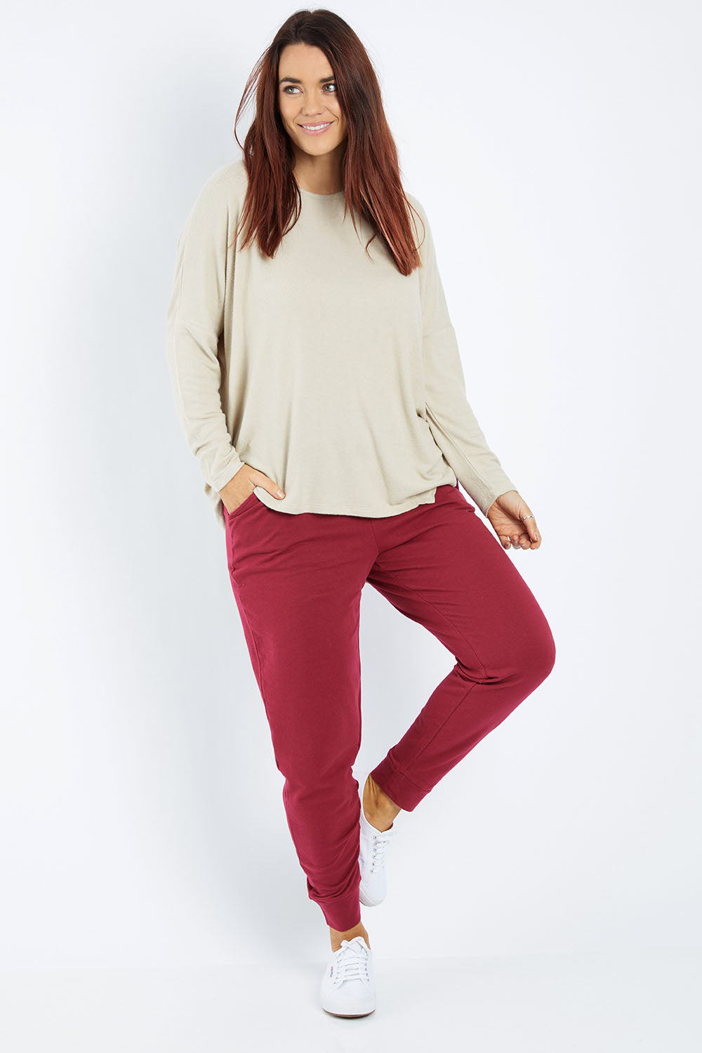 Model Laura wearing size 12 of the Lindsay Jogger in colour Wildberry (Red), from the front, showing the whole outfit