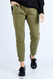 Model Madeline wearing size 10 of the Lindsay Jogger in colour Khaki (Green), from the front, cropped image