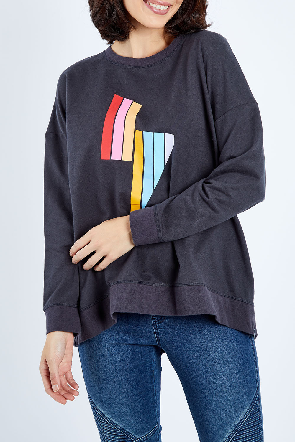Model Andrea wearing size 10 of the Poppy Sweat in colour Bolt (Grey), from the front, cropped image