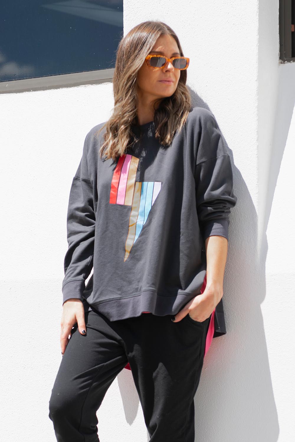 A model wearing the Poppy Sweat in colour Bolt (Grey), from the front, showing the whole outfit