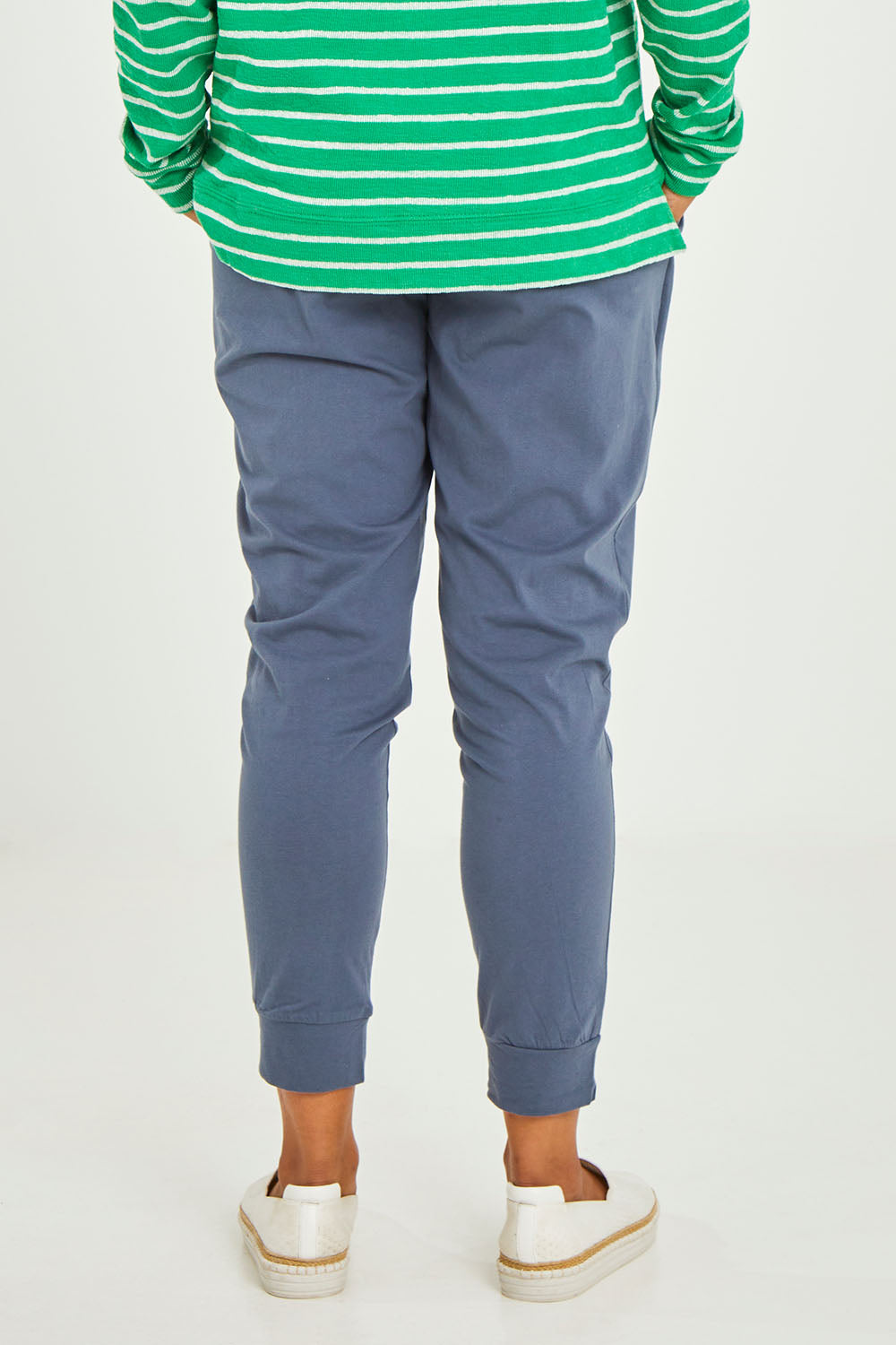 Model Olivia wearing size 10 of the Marissa Jogger in colour Indiblue (Blue), from the back
