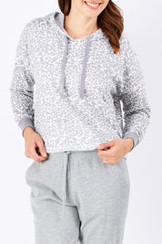 Model Rebecca wearing size 10 of the Oscar Hoodie in colour Leopard (Grey), from the front, cropped image
