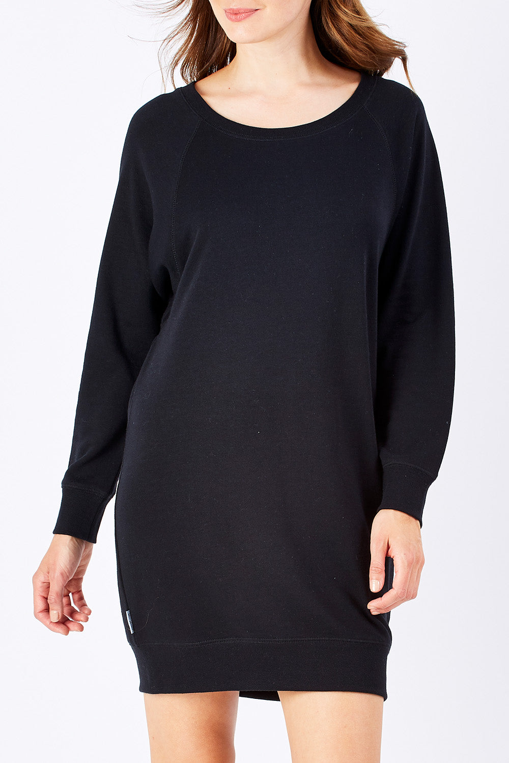 Model Rebecca wearing size 10 of the Zeke Sweater Dress in colour Black (Black), from the front, cropped image