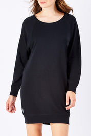 Model Rebecca wearing size 10 of the Zeke Sweater Dress in colour Black (Black), from the front, cropped image