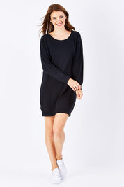 Model Rebecca wearing size 10 of the Zeke Sweater Dress in colour Black (Black), from the front, showing the whole outfit