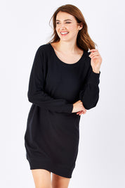 Model Rebecca wearing size 10 of the Zeke Sweater Dress in colour Black (Black), from the front, showing the whole outfit