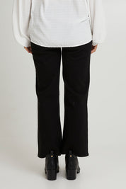 Model Katie wearing size 10 of the Nicola Bootleg Jean in colour Black (Black), from the back