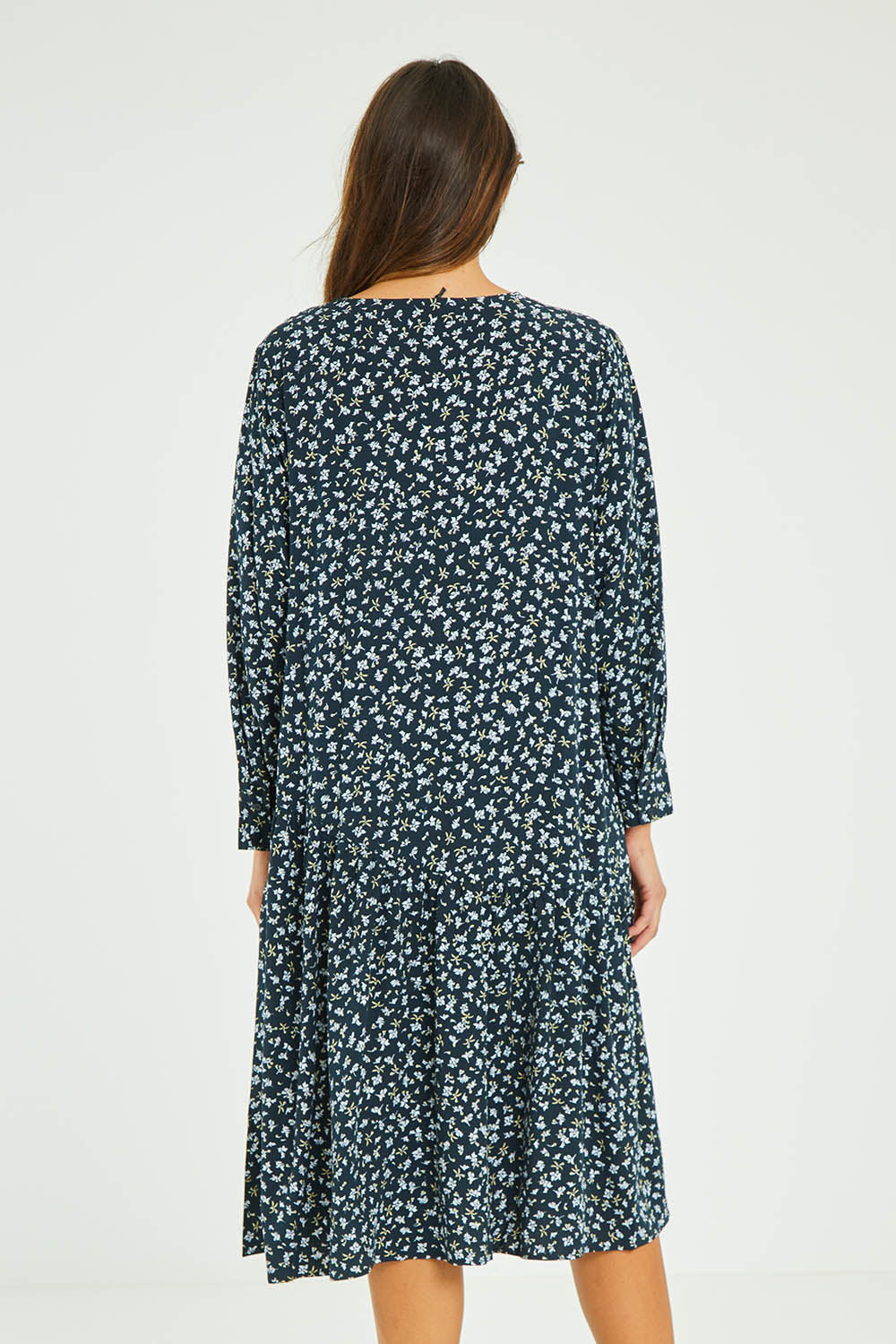 Model Madeline wearing size 10 of the Sharni Dress in colour Floral (Black), from the back