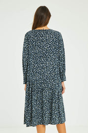 Model Madeline wearing size 10 of the Sharni Dress in colour Floral (Black), from the back